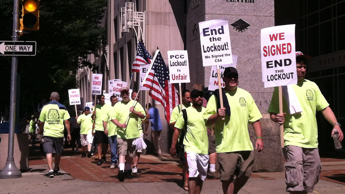  Teamsters and carpenters union members protest in front of the Pennsylvania Convention Center Wednesday. (Steve Trader/ for NewsWorks) 