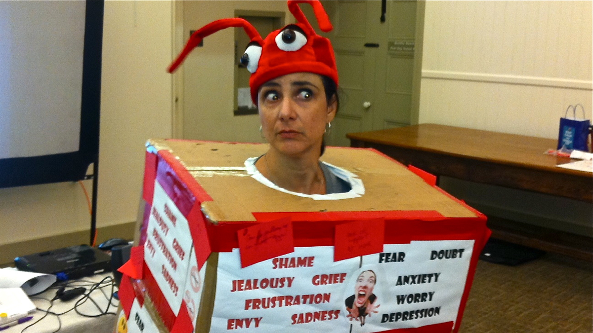  Christa Scalies is dressed up in a 'common stressors' costume, and is encouraging workshop participants to pelt her with marshmallows (Maiken Scott/WHYY) 
