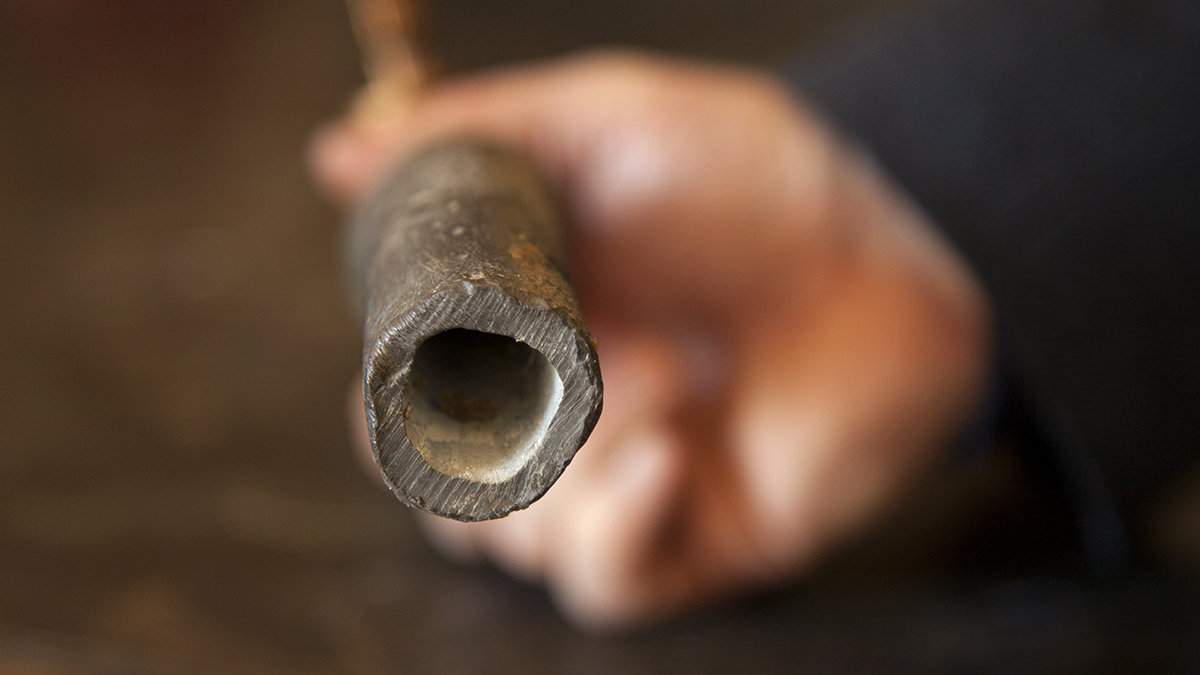 The inside of a lead pipe with a biofilm intact.  Biofilms consist of organic and inorganic matter that acts as a wall between the lead surface and the water. (Irina Zhorov/WESA) 