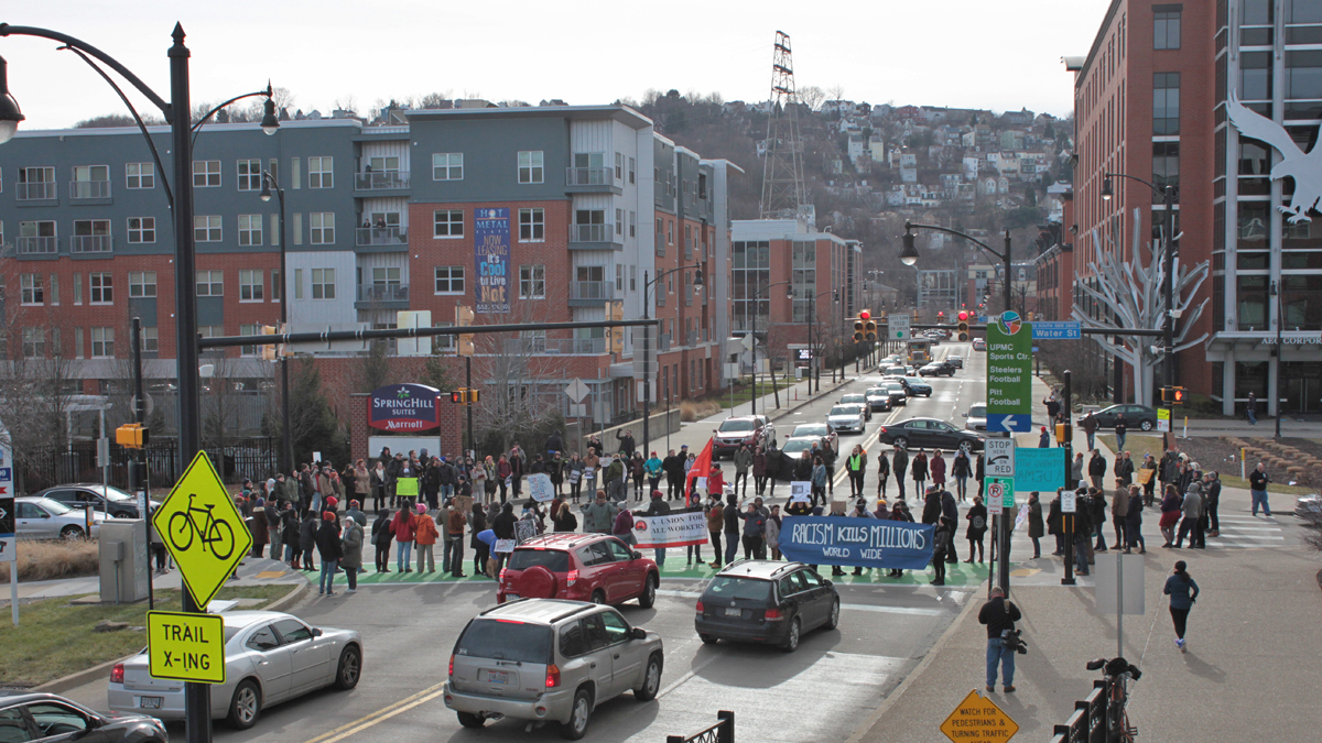 More than a hundred people formed a circle in the middle of a busy Pittsburgh intersection to demonstrate for the rights of immigrants before marching to an ICE field office in Pittsburgh