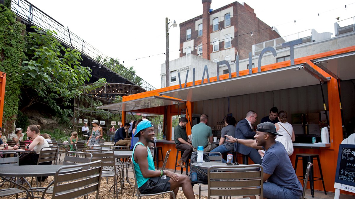 Patrons gather at the 2016 PHS pop-up garden at 10th and Hamilton Streets in Philadelphia's Callowhill District.  PHS built the pop-up garden to bring awareness to the planned Rail Park. (Lindsay Lazarski/WHYY)