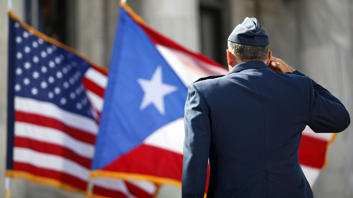  A U.S. Army honor guardsman salutes the Puerto Rican and U.S. flags during the inaugural ceremony for governor-elect Alejandro Garcia Padilla, at the Capitol building in San Juan on Wednesday, Jan. 2, 2013. Puerto Ricans endorsed U.S. statehood for the Caribbean island — and in the same election ousted pro-statehood governor Luis Fortuno. (AP Photo/Ricardo Arduengo) 