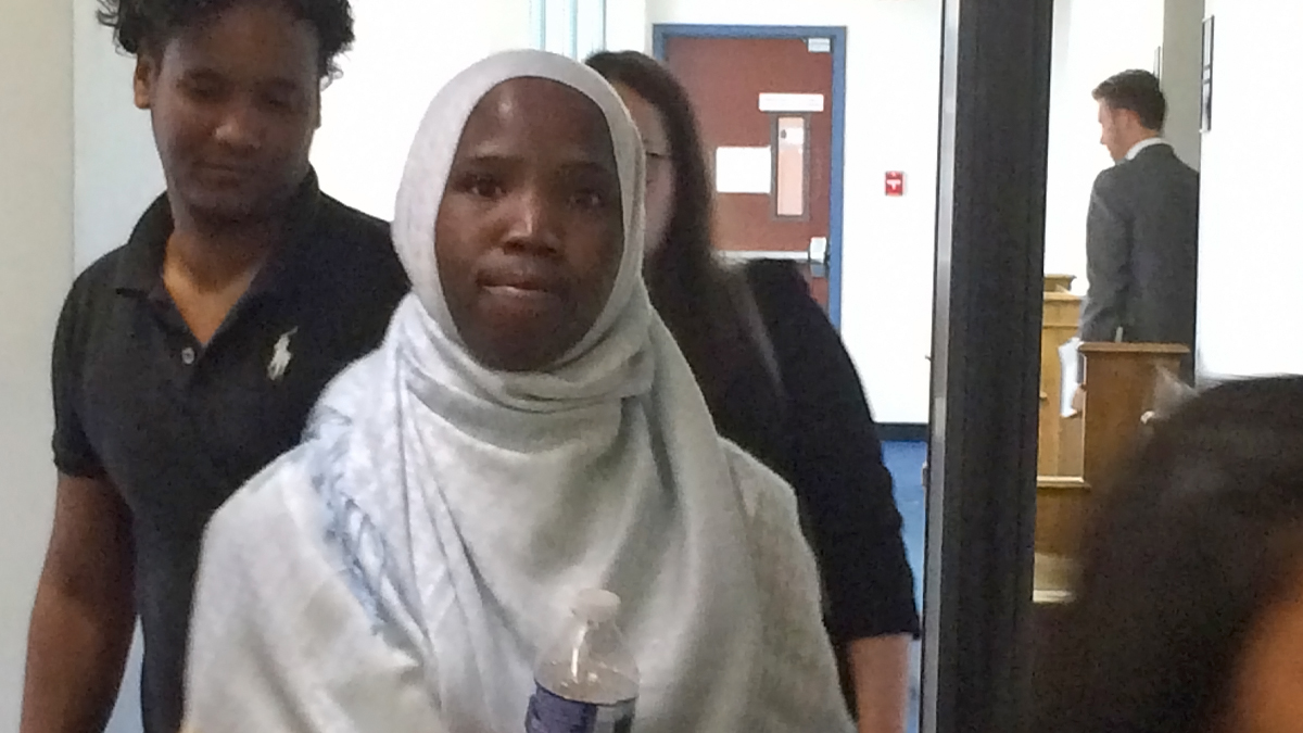 Qasim Hassan (left) and Khadidja Issa (center) leave federal court in Easton after testifying against the School District of Lancaster.  Six student refugees are suing the district for allegedly denying them equitable education opportunities. Hassan's family fled Somalia after his father was killed in the civil war there. Issa's family fled Sudan and spent a decade in a refugee camp before being resettled in Lancaster. (Emily Previti/WITF)