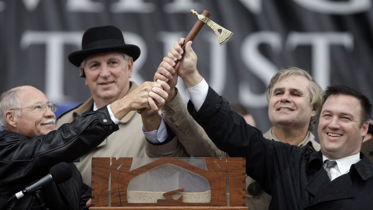 Leaders of Sussex County's political parties hold up an axe during a previous 