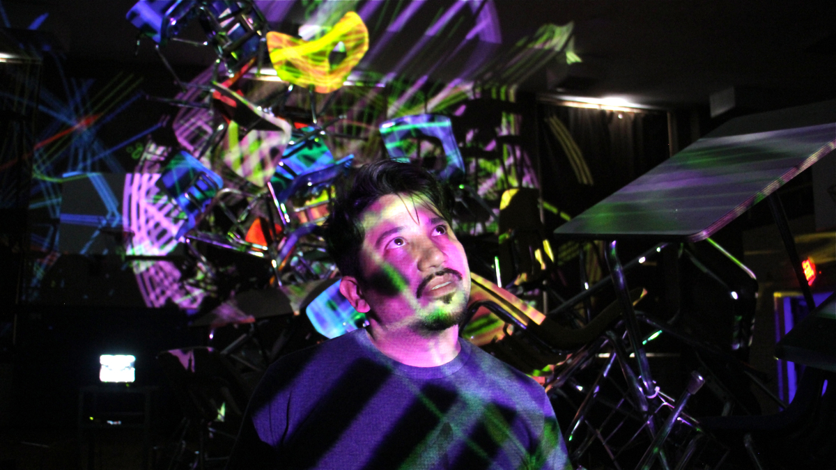 Klip Collective director Ricardo Rivera stands amid his immersive installation at Bok Technical School