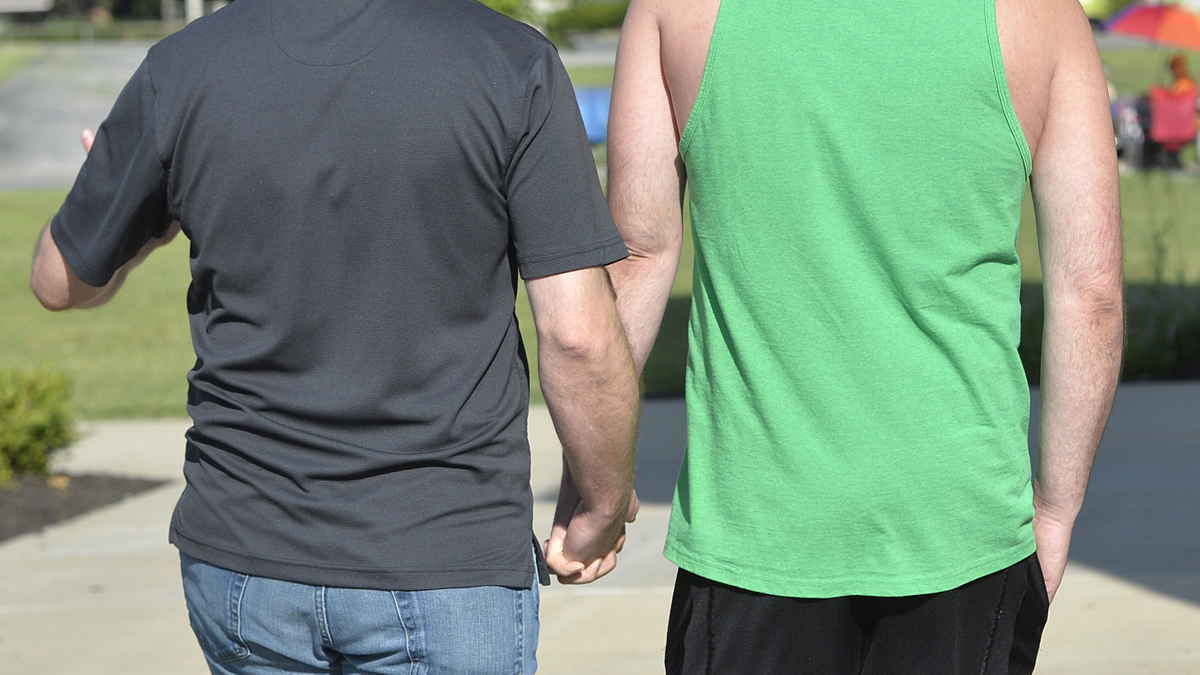 James Yates, left, and William Smith Jr. head into the Rowan County Courthouse to obtain a marriage license in Morehead, Ky., Thursday, Aug. 13, 2015. In a decision on Wednesday, U.S. District Judge David L. Bunning ordered Rowan County Clerk Kim Davis to issue marriage licenses, but she has refused after filing an appeal to the ruling to the Sixth Circuit Court of Appeals. (AP Photo/Timothy D. Easley)