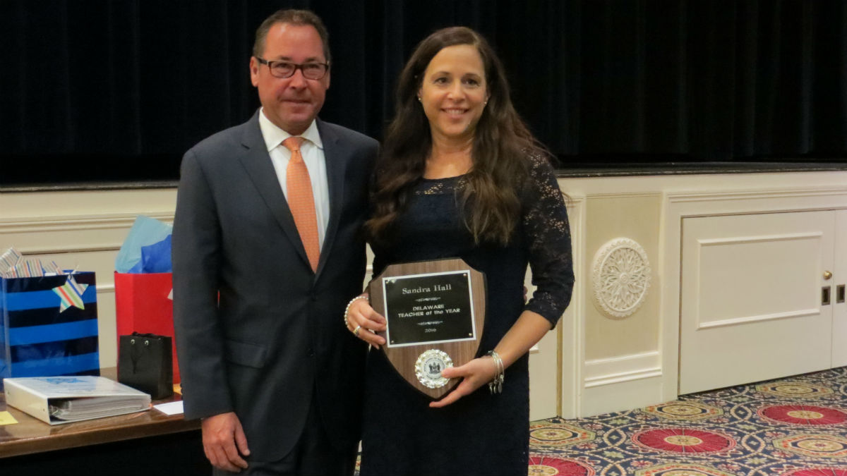  Sandra Hall (right) poses with her plaque for Delaware teacher of the year. (Avi Wolfman-Arent, NewsWorks/WHYY) 