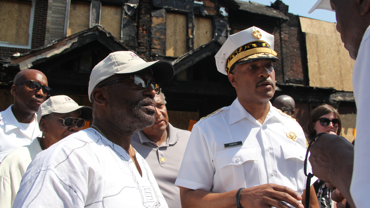  Philadelphia Fire Commissioner Derrick Sawyer meets with residents of Gesner Street, where a fire claimed the lives of four children. (Emma Lee/WHYY) 