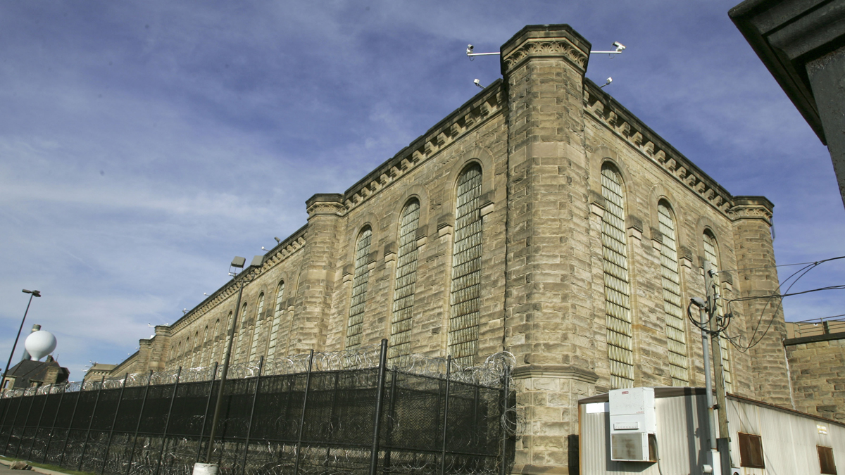 Fences and razor wire are seen around the yards behind the former State Correctional Institution in Pittsburgh. (AP File Photo/Keith Srakocic)