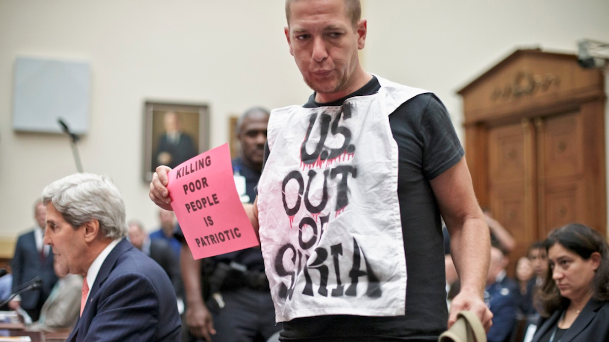  As Secretary of State John Kerry testified on Wednesday, an anti-war protestor left a House Foreign Affairs Committee hearing on President Barack Obama's request for congressional authorization for military intervention in Syria, a response to last month's alleged sarin gas attack in the Syrian civil war. (AP Photo/J. Scott Applewhite) 