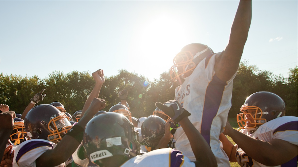  The MLK High Cougars football team celebrates its first win of the season on Friday at Bartram High's stadium. (Brad Larrison/for NewsWorks) 