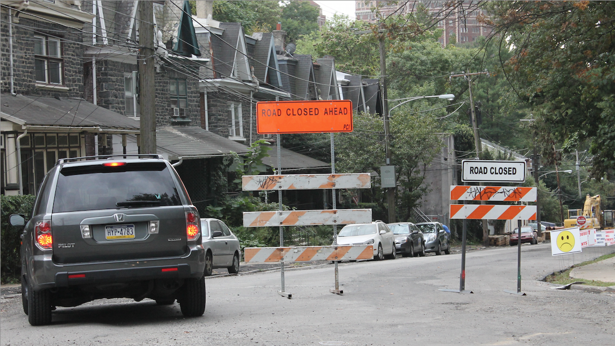  A driver considers ignoring detour signs on Rittenhouse Street in Germantown. Four other motorists in a little under 10 minutes weren't quite as reluctant. (Matthew Grady/for NewsWorks) 