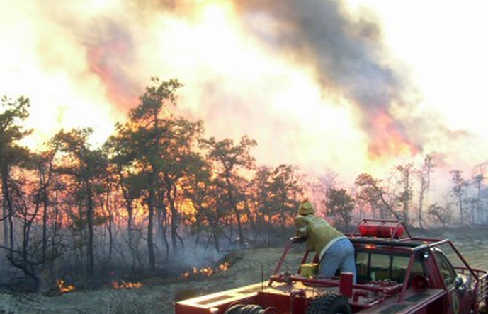  A firefighter on the scene of a fire at Warren Grove in southern Ocean County in 2004.  