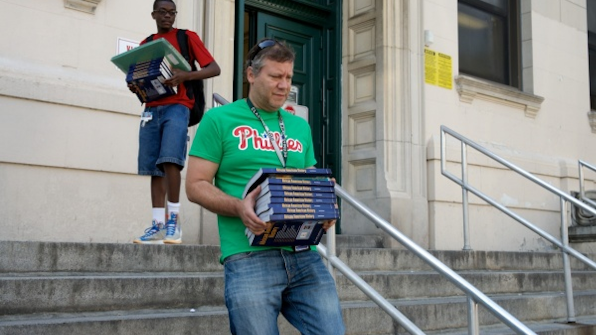  Teacher Jessy Warren and a student carried books out of Germantown High on the last day of school in June. (Bas Slabbers/for NewsWorks) 