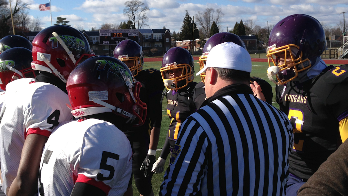  Delane Hart (far right, shown here at the pregame coin flip) would catch the game-winning pass in Thursday's 'Legacy Bowl' game between the MLK Cougars and Imhotep Panthers. (Brian Hickey/WHYY) 