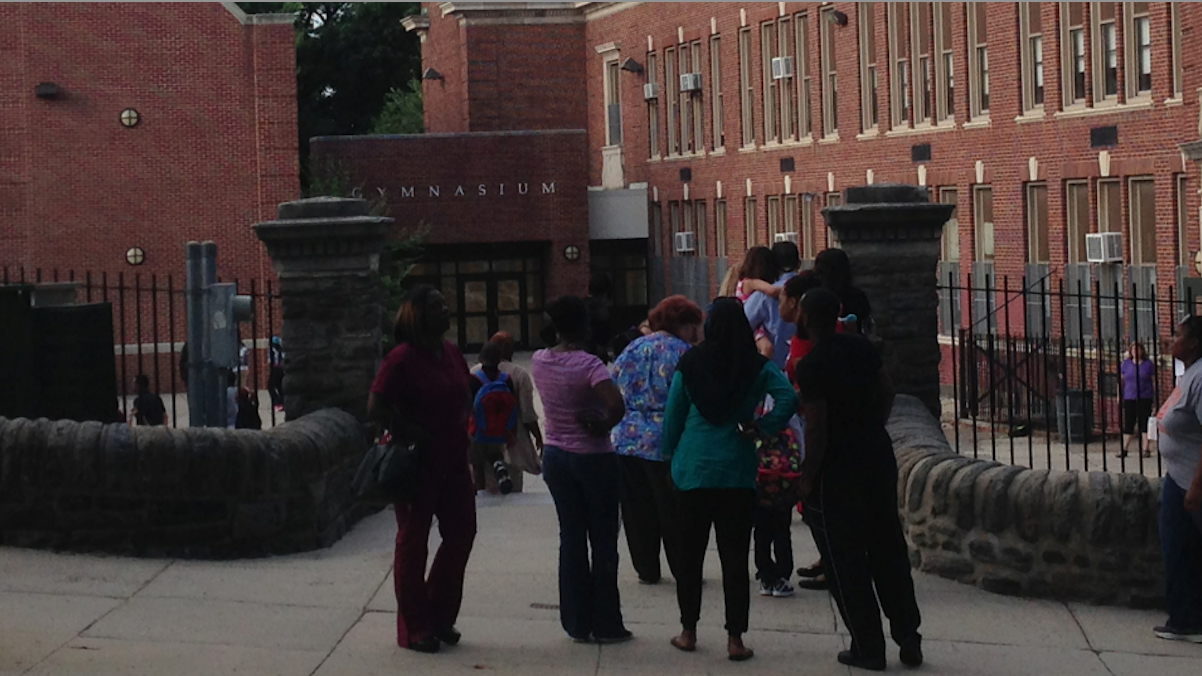 Parents see their children off to the first day of classes at Thomas Mifflin School in East Falls on Monday morning. (Brian Hickey/WHYY) 
