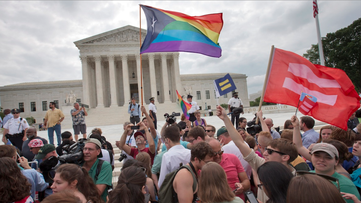  The crowd reacts as the ruling on same-sex marriage was announced outside of the Supreme Court on Friday. (AP Photo/Jacquelyn Martin) 