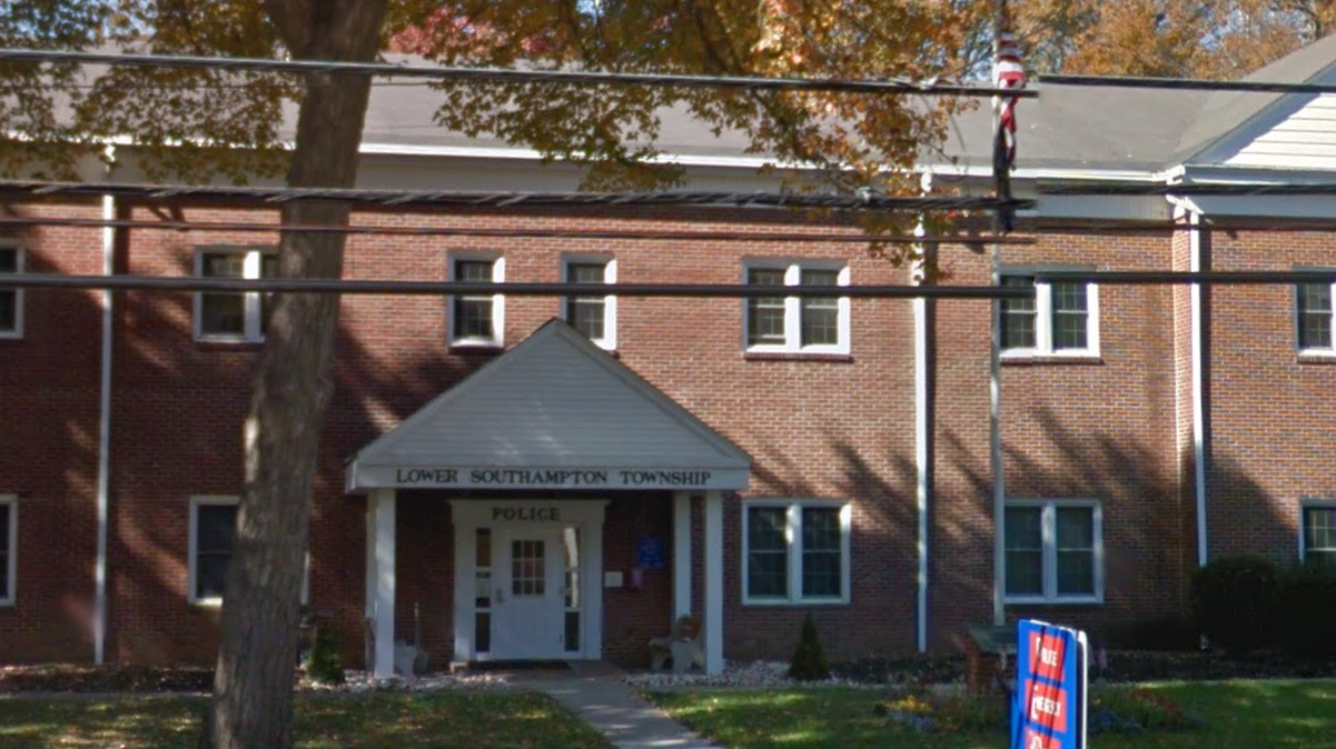 A red brick building seen from afar.