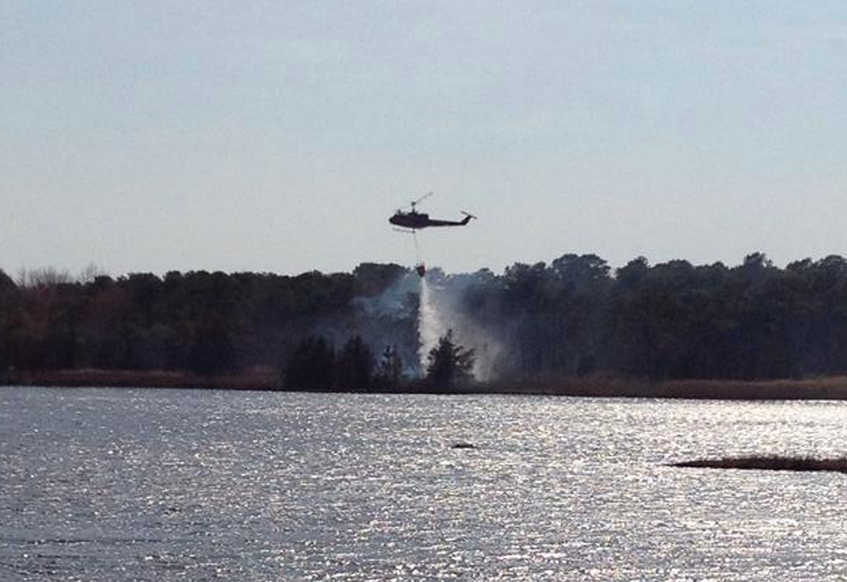  A New Jersey Forest Fire Service helicopter dropping water over a wildfire off Jordan Road in Brick Sunday afternoon. (Photo: Jersey Shore Hurricane News contributor Josh Bickert) 