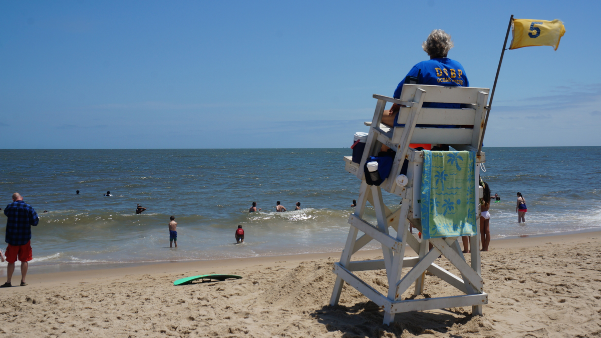 A lifeguard on duty at Cape Henlopen State Park. Learning which combinations of beach features are correlated with injuries may allow real-time prediction of when it's most dangerous--and for lifeguards to warn swimmers away. (Jessica McDonald/WHYY)
