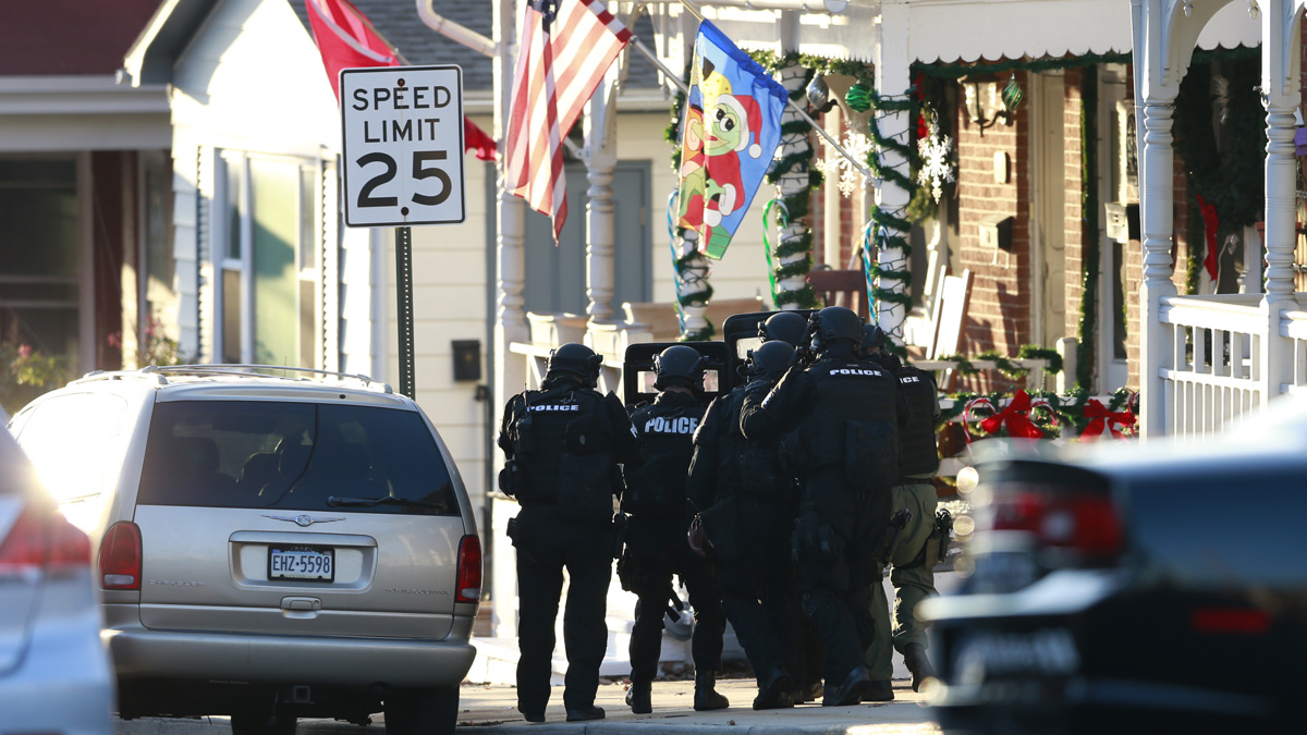  Police cordon off a wooded area during the search for Bradley William Stone, Tuesday in Pennsburg. Schools closed and hospitals and other public places tightened security Tuesday as police in suburban Philadelphia hunted for the Marine veteran suspected of killing his ex-wife and five of her relatives. (Matt Rourke/AP Photo) 