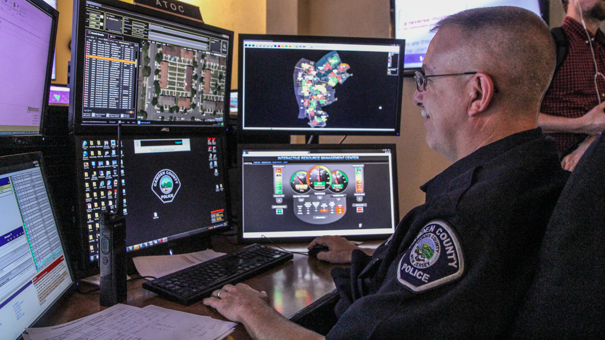  Patrolman Larry Cox said the ShotSpotter can identify the location of a  gunshot. (Kimberly Paynter/WHYY) 