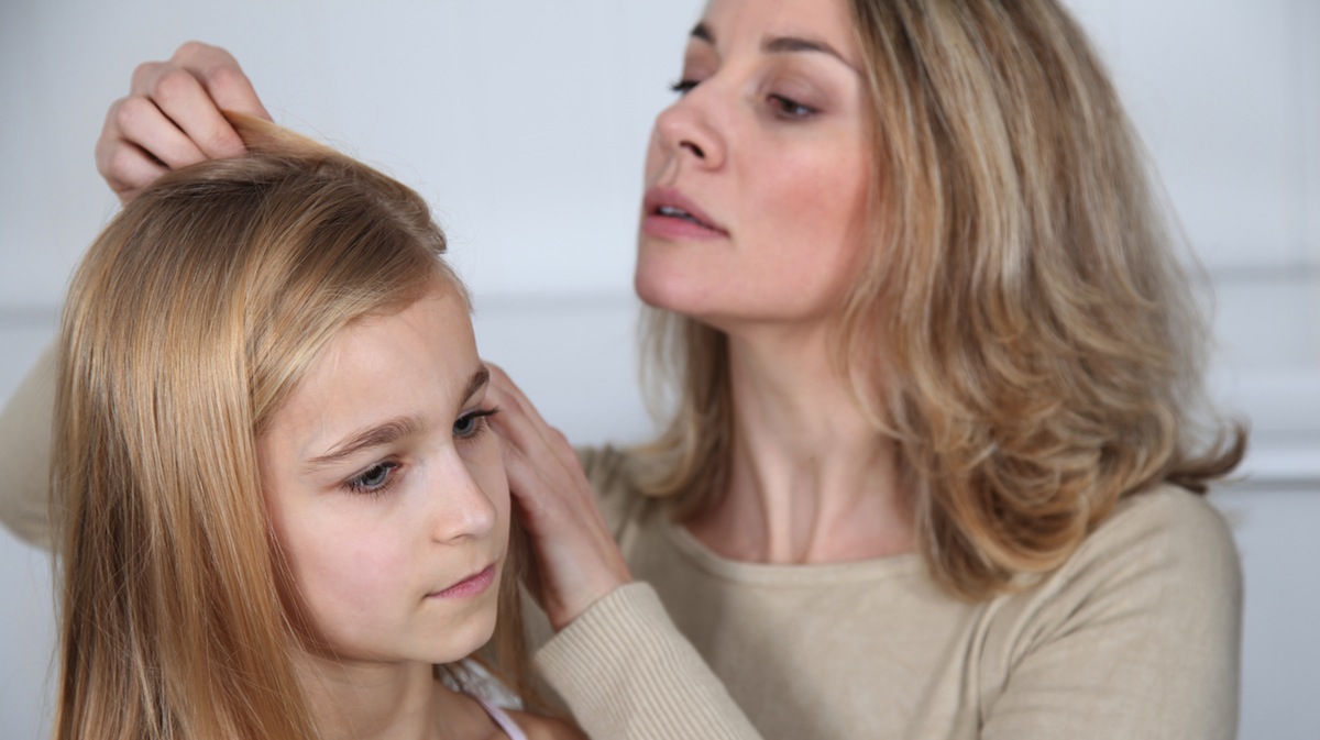  Mother treating daughter's hair against lice image courtesy of Shutterstock.com 