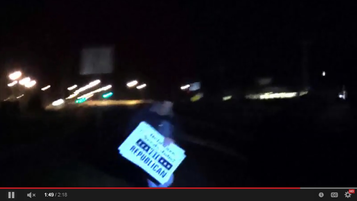  This still from video posted on YouTube shows a man taking Republican signs. (YouTube) 