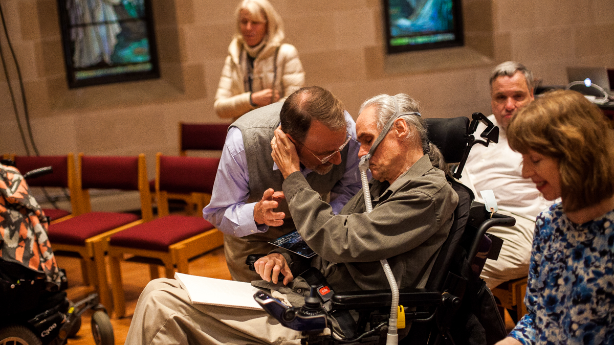 David L. Simpson speaks with friend Bill Strunk before the start of Crossing the Threshold into the House of Bach. (Brad Larrison/for NewsWorks)