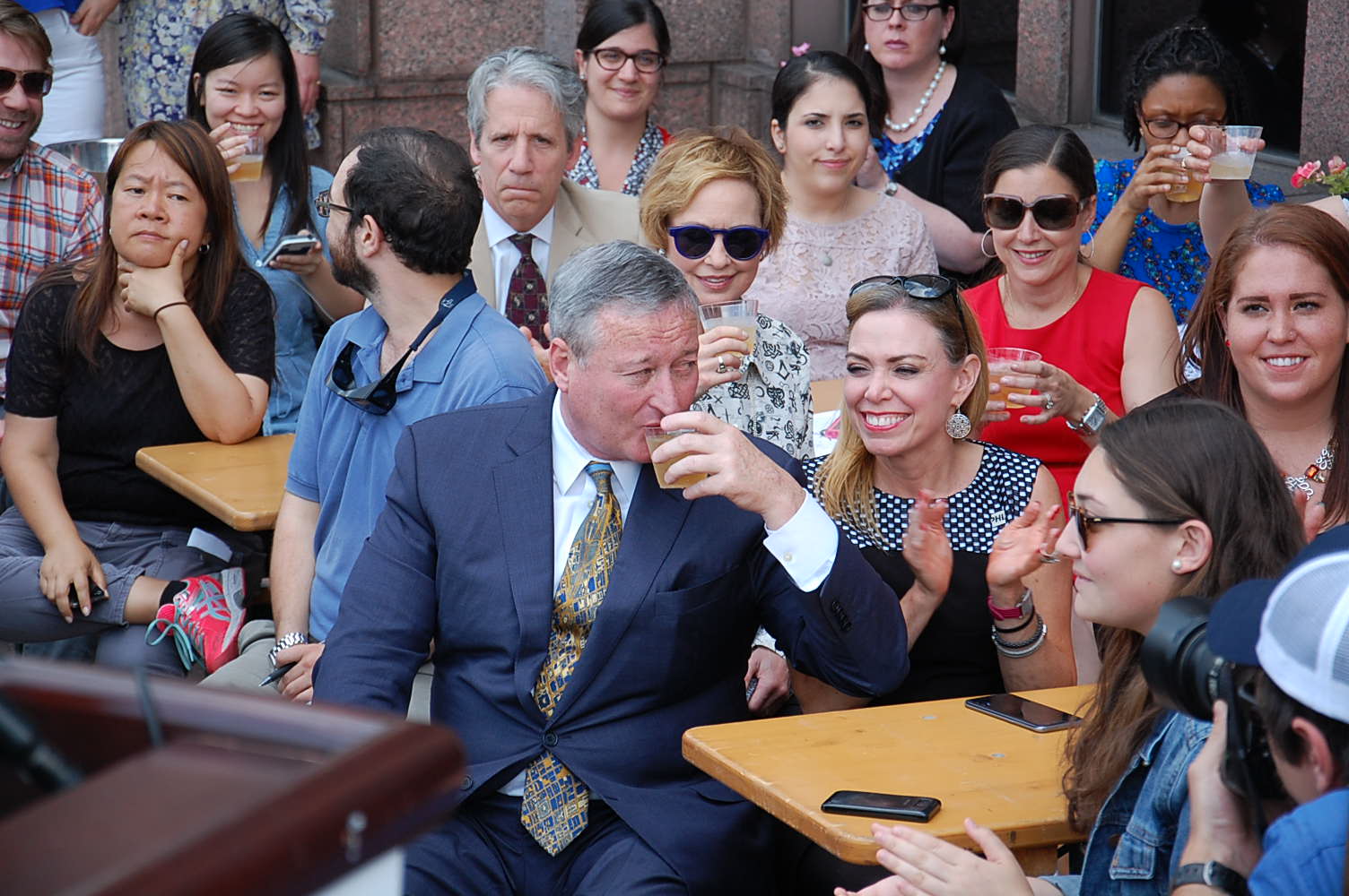 Mayor Kenney joins a crowd toasting efforts to keep residents in town during the Democratic National Convention.  (Tom MacDonald/ WHYY)