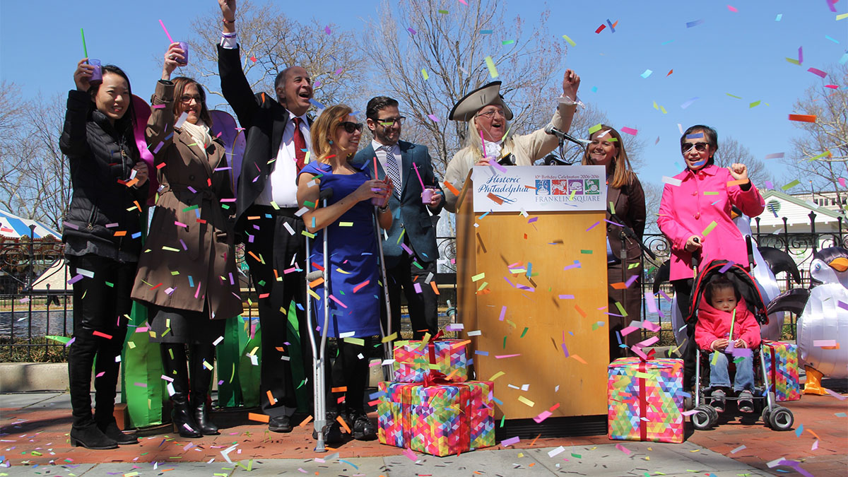  Officials raise a cake shake to toast Franklin Square's 10th re-birthday party. (Emma Lee/WHYY) 