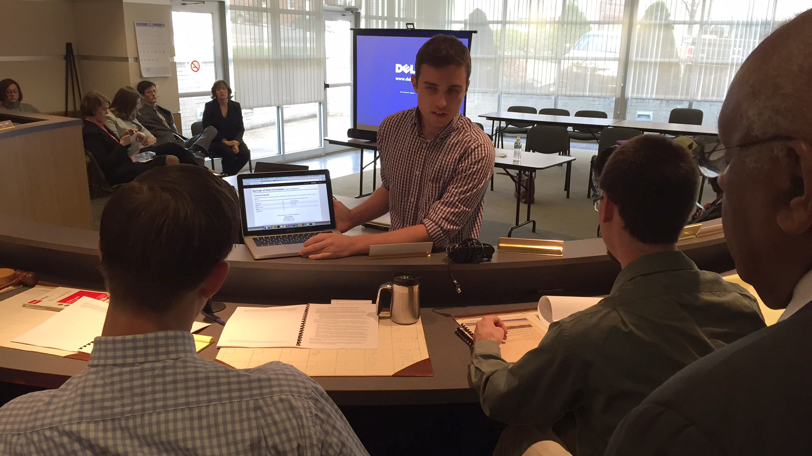  Student Elliott Spencer Bingol shows borough manager Kyle Thauvette of West Homestead (on the left) and Ian McMeans of Homestead (on the right) how the digitized forms he created work. (Irina Zhorov/WESA)  