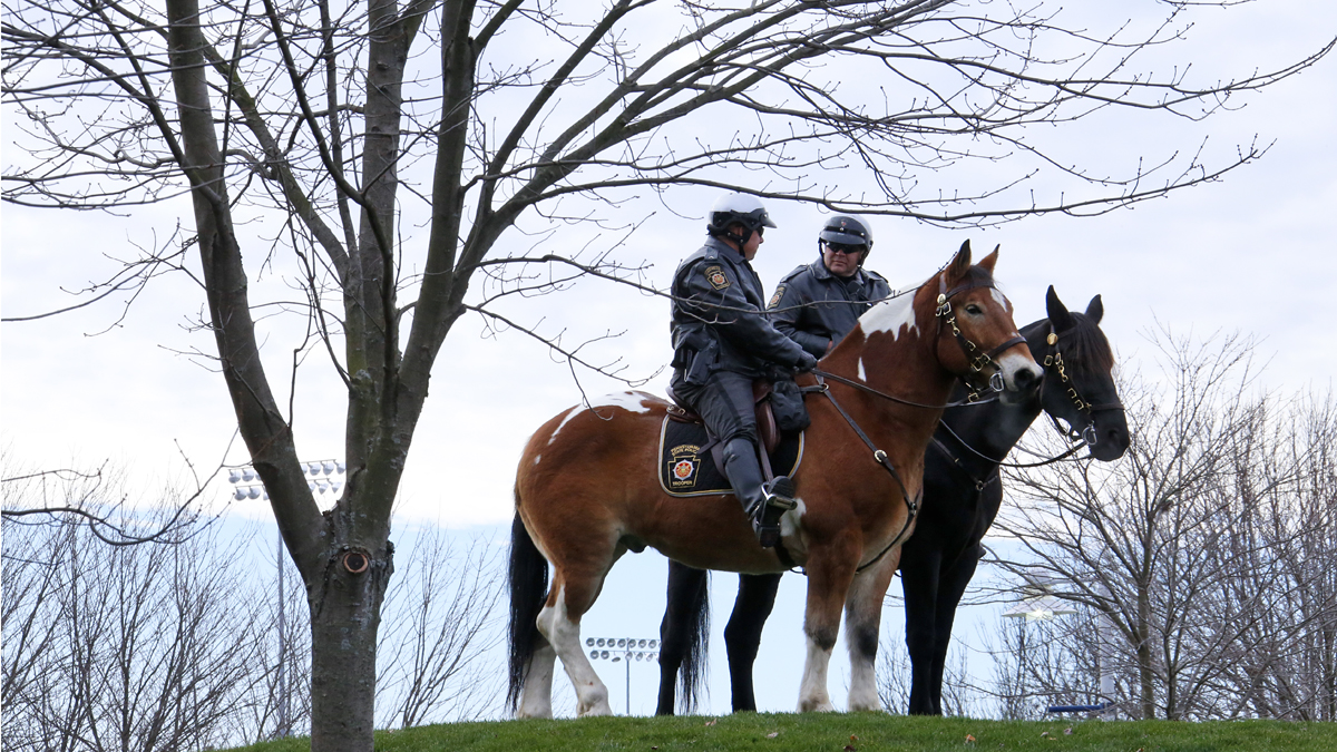 Pennsylvania State Police on horses outside Beaver Stadium before an NCAA college football game between the Penn State and the Michigan State in State College