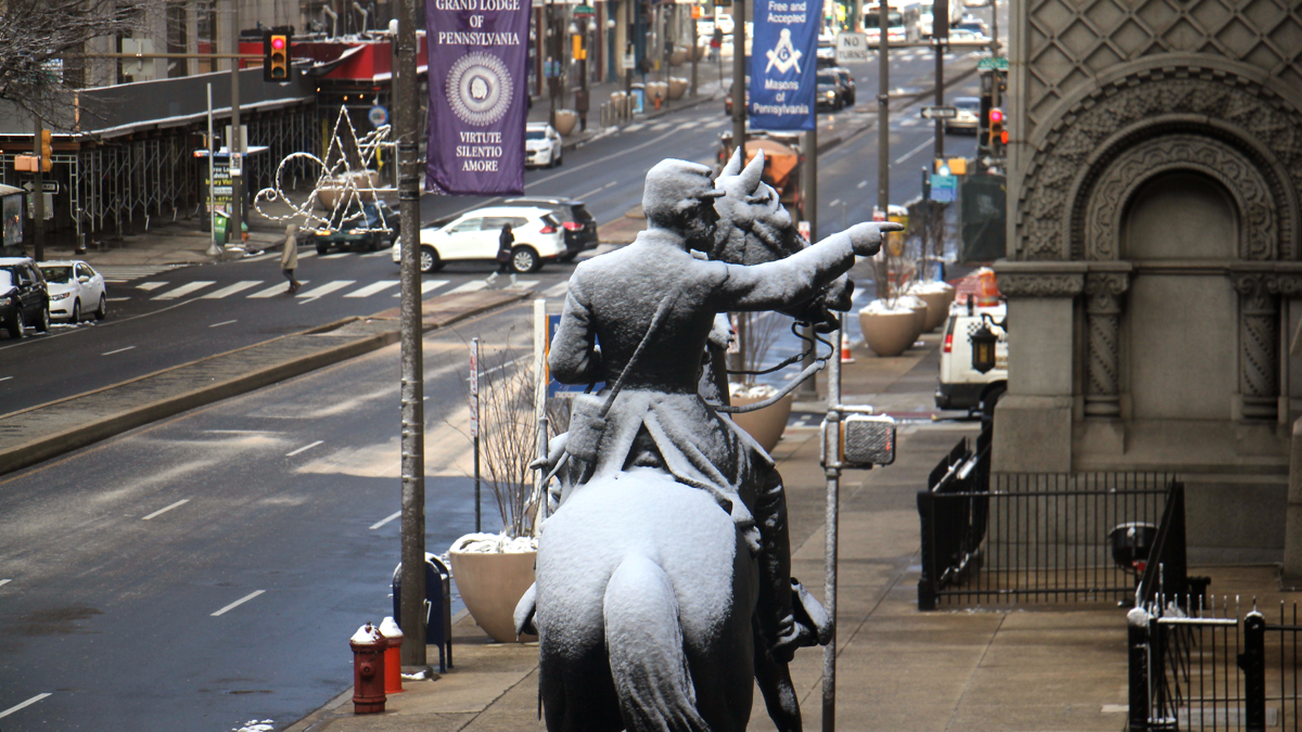 The snow-dusted encrusted statue of a Civil War soldier outside City Hall looks out upon an otherwise snow-free Center City. (Emma Lee/WHYY)