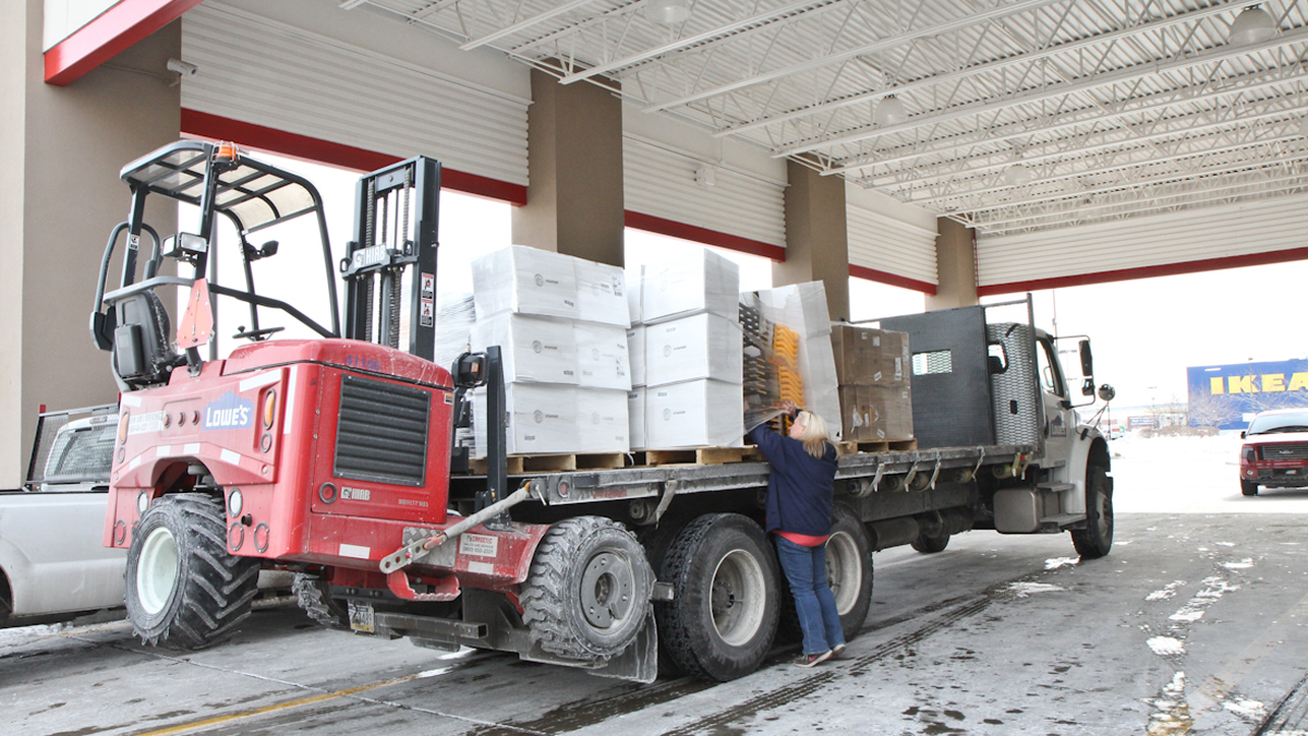  Workers at Lowe's in South Philadelphia were busy pulling shovels off of trucks Wednesday morning. (Kimberly Paynter/WHYY) 