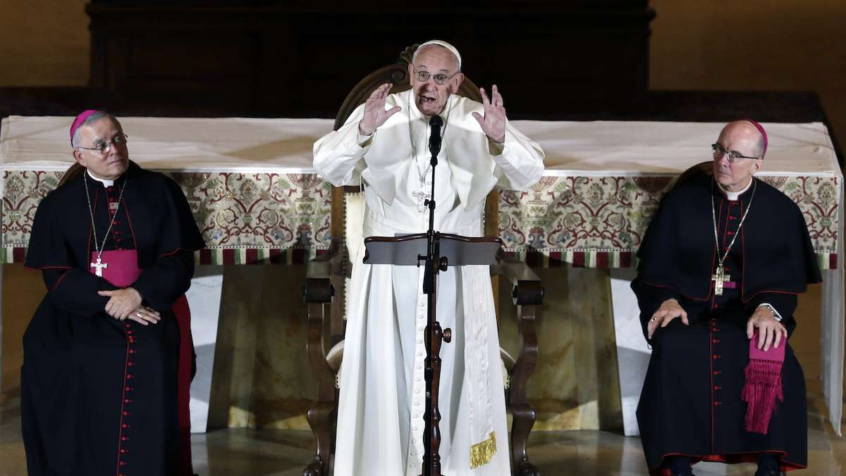  Archbishop Charles Chaput, left, and Bishop Timothy Senior, right, listen as Pope Francis addresses a gathering in Saint Martin's Chapel at St. Charles Borromeo Seminary on Sunday in Wynnewood, Pa. (AP Photo/Mel Evans) 