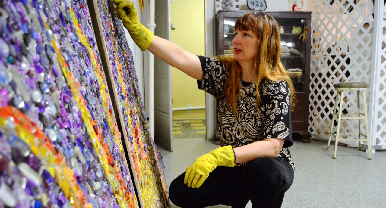  Kim East works on a mosaic sign for the front of the Tamaqua Community Arts Center, which opened in 2012. The development of an arts community is a big part of Tamaqua's vision for revitalization. Read more about Tamaqua under the heading “Community revitalization.” (Chanukah Christie/WPSU) 