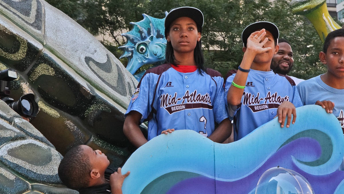  Taney star pitcher Mo'ne Davis rides in a parade celebrating the team after their return from the Little League World Series. (Kimberly Paynter/WHYY) 