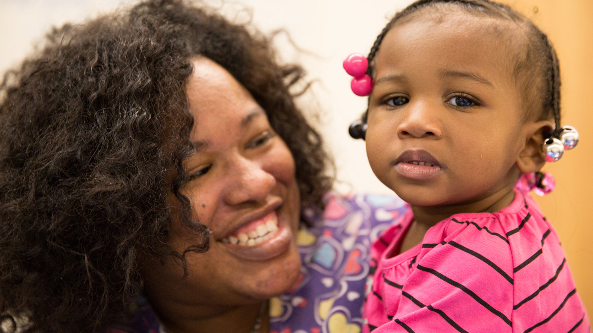  Barretta Freeman of Chester, with one of her children, is a pastparticipant in the Healthy Start program in DelawareCounty. (Image courtesy of Crozer-Keystone Health System) 