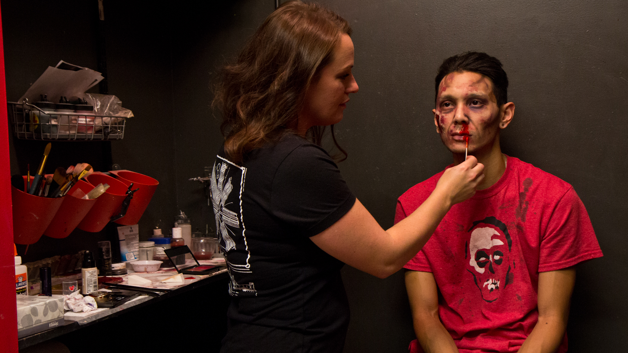 Terror Behind the Walls' Special Effects Makeup Director Lauren Palmer transforms fellow makeup artist Daniel T. McDonald into a zombie with just a few items that can be purchased anywhere makeup is sold. (Kimberly Paynter/WHYY)