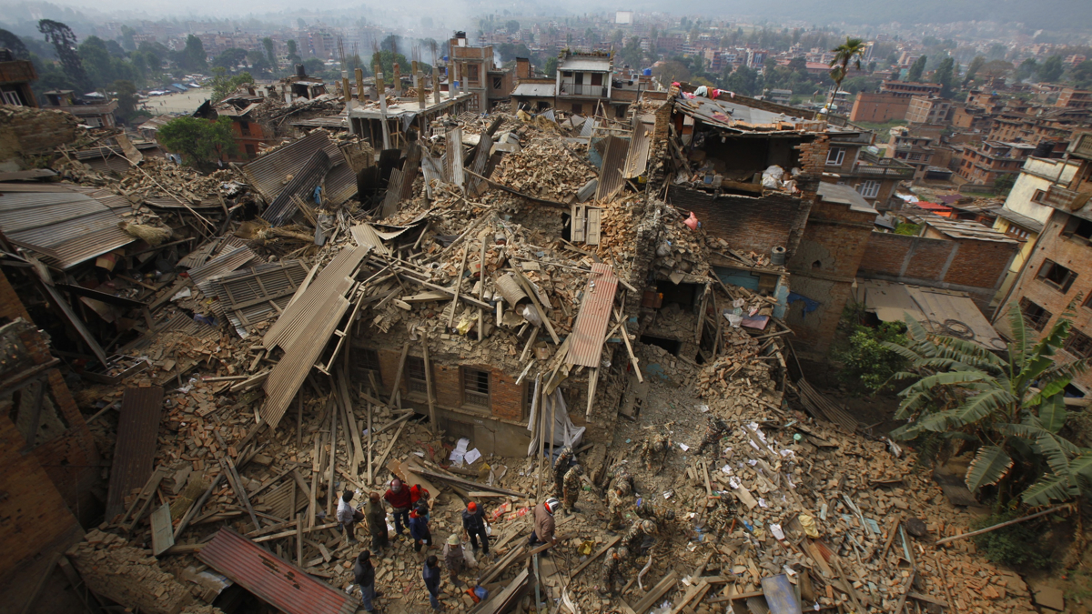 Rescue workers remove debris as they search for victims of earthquake in Bhaktapur near Kathmandu
