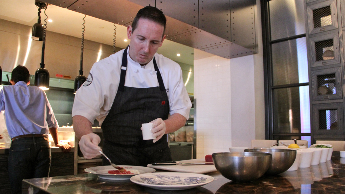 Chef Thomas Hawkins prepares tuna with yogurt, chile, and mint at Bank & Bourbon on Market Street. (Emma Lee/WHYY)