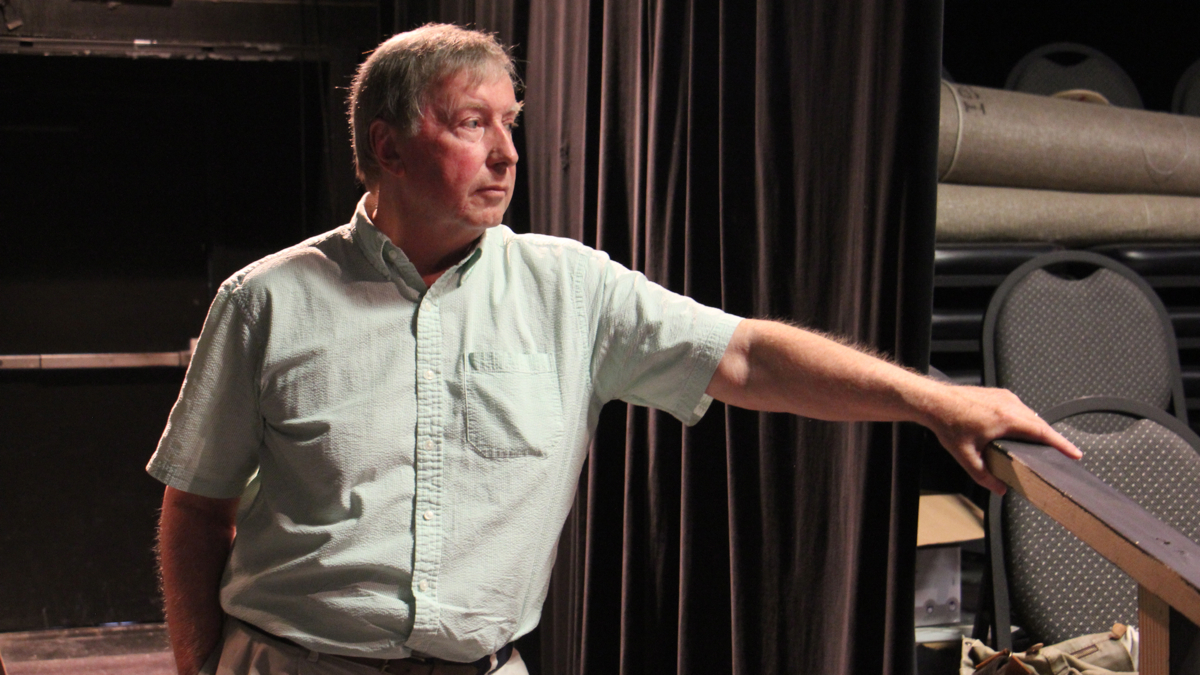 Ray Didinger stands watching a rehearsal of his play.