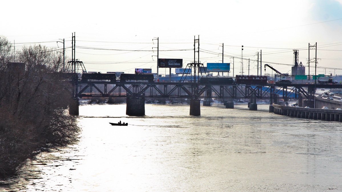  7 cars of a 101-car train traveling from Chicago to a refinery in South Philadelphia slid off the tracks on the Schuylkill Arsenal Bridge around 12:30 a.m. Monday.  Crews are still working to clear the tracks Thursday afternoon. (Kimberly Paynter/WHYY) 