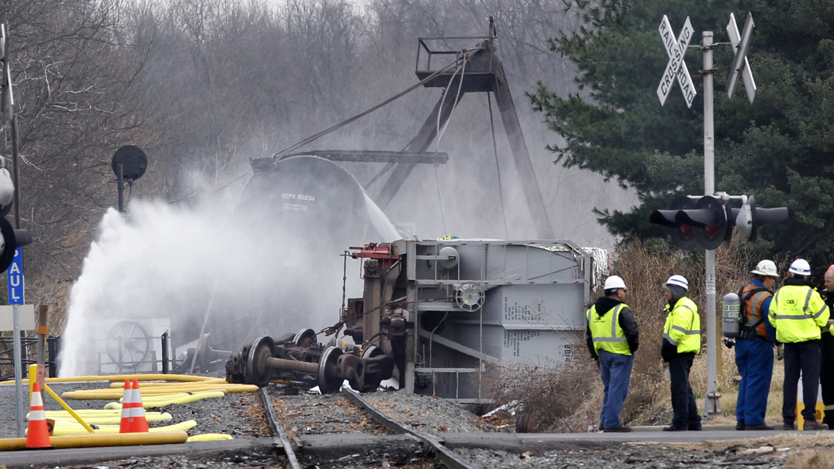 Crews spray water on derailed freight train tank cars in Paulsboro
