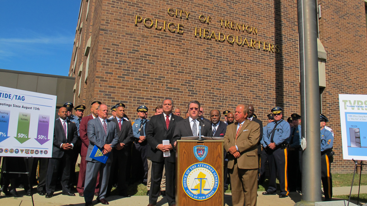  Flanked by law enforcement officials outside Trenton Police Headquarters, acting New Jersey Attorney General John Hoffman announced news strategy to reduce violence. (Phil Gregory/for NewsWorks) 