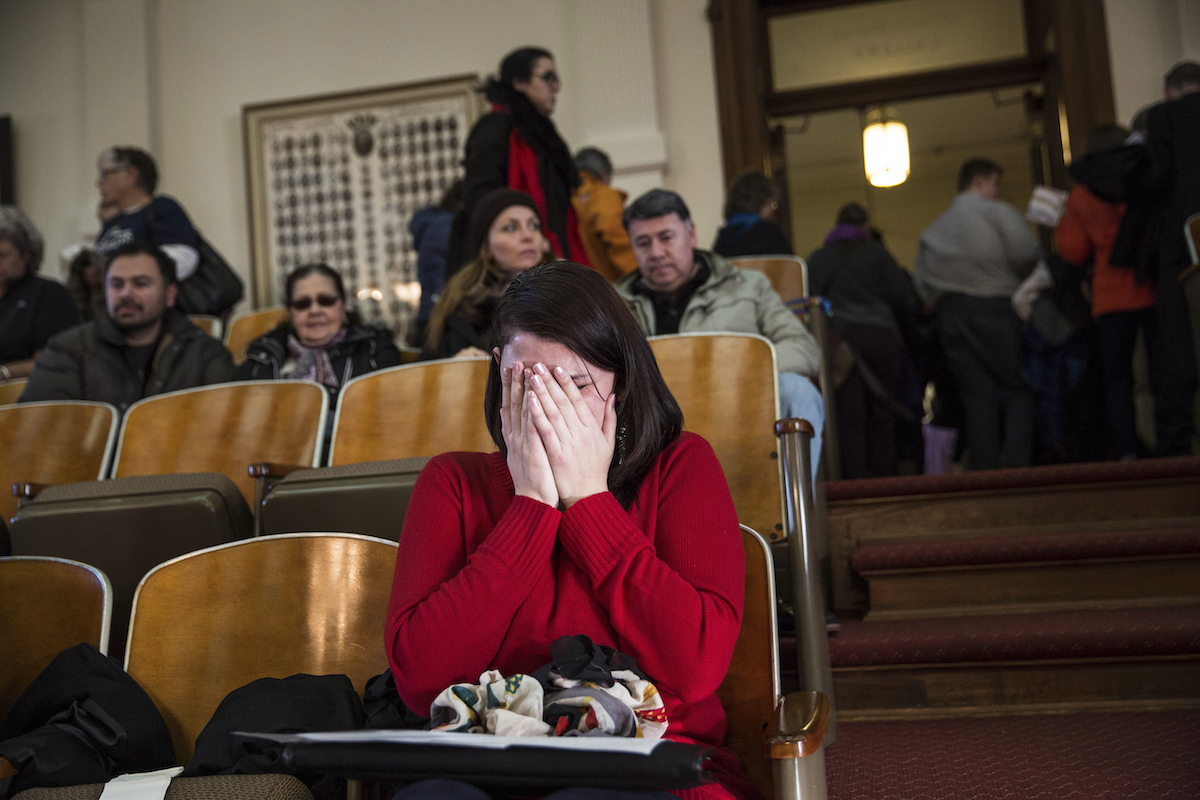A woman cries in the gallery of the House of Representatives after the Electoral College voted at the state Capitol in Austin