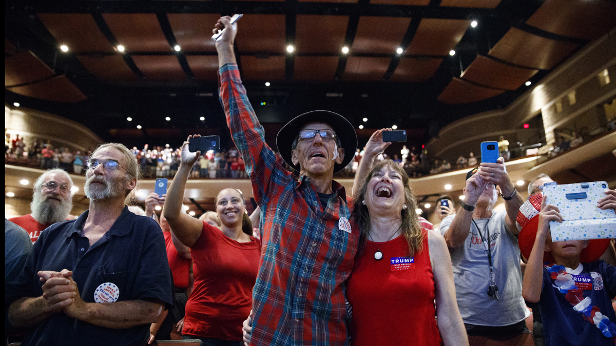 Supporters of Republican presidential candidate Donald Trump look on as he speaks to an overflow room during a campaign rally at Cumberland Valley High School