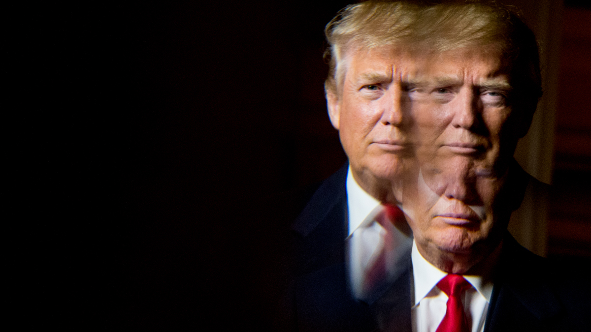  Republican presidential candidate Donald Trump, seen in reflection, poses for a portrait following an interview with the Associated Press at the Trump National Golf Club in Sterling, Va., Wednesday, Dec. 2, 2015. (AP Photo/Andrew Harnik) 