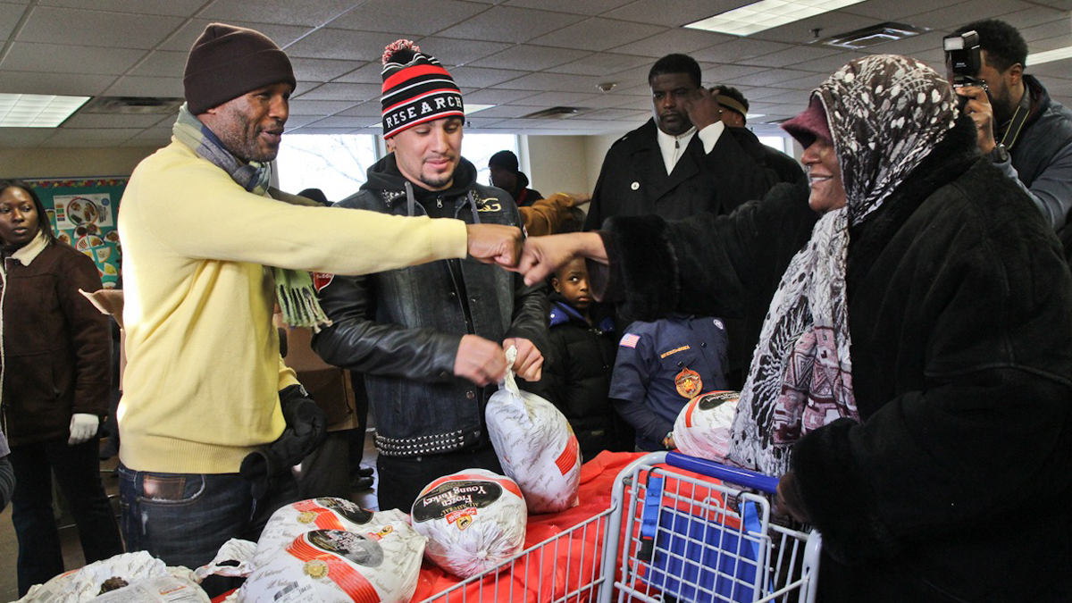  Jacqueline Jax fist bumps boxing champion Bernard Hopkins, she said she knew him from their younger days in the neighborhood. (Kimberly Paynter/WHYY) 